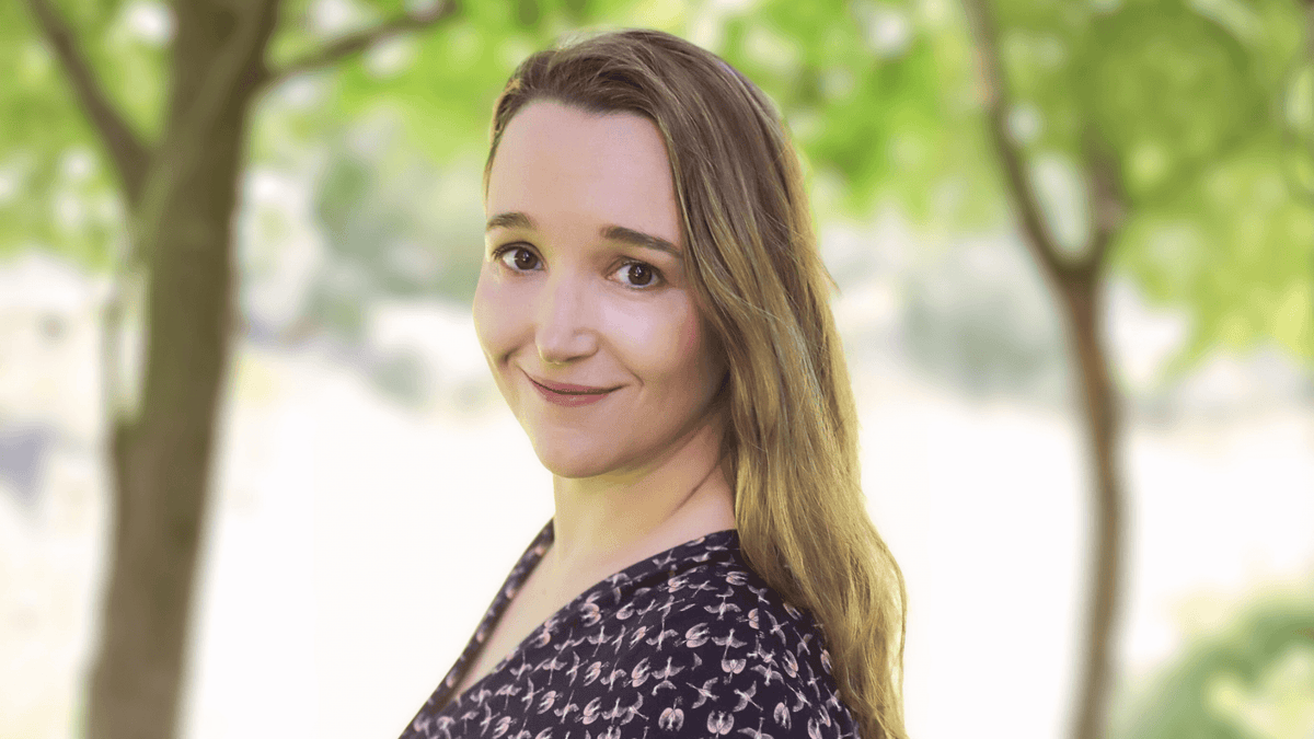 Dr Mandy Leonhardt, GP and female health expert, smiling outdoors under trees.