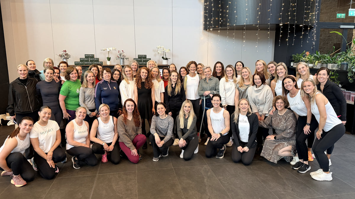 A SISTERLY Circle community event: a large group of women gathered after a wellness class