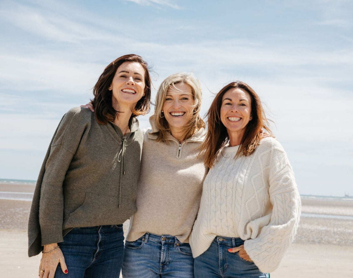 SISTERLY founders Aoife, Jenny and Louise smiling together on the beach